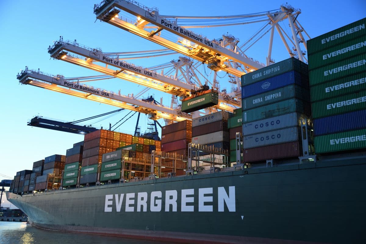 Container ship loaded with shipping containers, representing imported first aid kits sold as DIN 13164 compliant